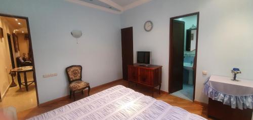 a bedroom with a bed and a table and a mirror at Guest house YEREVAN in Yerevan
