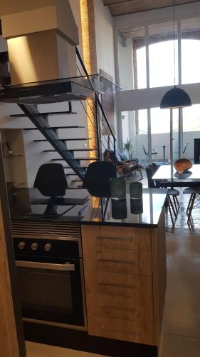 a kitchen with a stove top oven in a room at Loft Mariola - Apartamento en el centro histórico in Bocairent