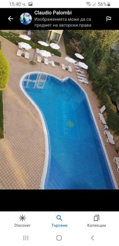 a picture of a swimming pool with chairs and umbrellas at Golden Dreams in Sunny Beach