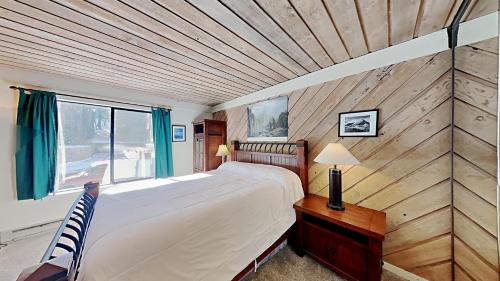 a bedroom with a large bed and a window at One Bedrooms At Snowbird Condos Slopeside - Free Wifi & Assigned Parking! in Mammoth Lakes