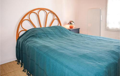 a bedroom with a bed with a blue blanket at 1 Bedroom Lovely Apartment In Noirmoutier-en-lle in Noirmoutier-en-l'lle