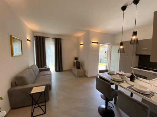 a living room with a couch and a table at Relaxing Home in Tignale