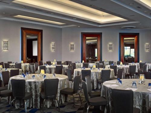 a room filled with tables and chairs with white tablecloths at The Royal Sonesta Boston in Cambridge