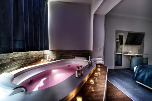 a bathroom with a large pink bath tub at Suite Blue Style in Rome