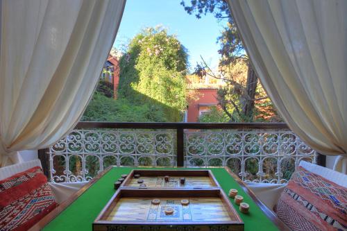 a green table in a room with a window at Riad Kaiss By Anika in Marrakech