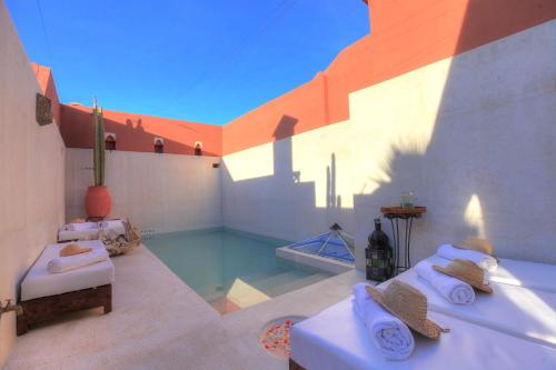 a room with a swimming pool in a house at Riad Kaiss By Anika in Marrakech