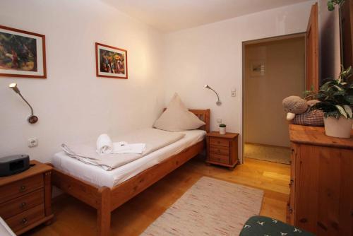 a small bedroom with a bed and a table at Chaletwohnung Allgäutraum in ruhiger Lage von Burgberg unterhalb vom Grünten in Burgberg