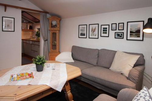 a living room with a couch and a table at Chaletwohnung Allgäutraum in ruhiger Lage von Burgberg unterhalb vom Grünten in Burgberg