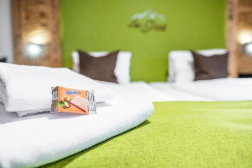 a hotel room with two beds with a box on them at AlpinSpa zur Post - Bergbahn im Sommer 2025 inklusive in Bad Gastein
