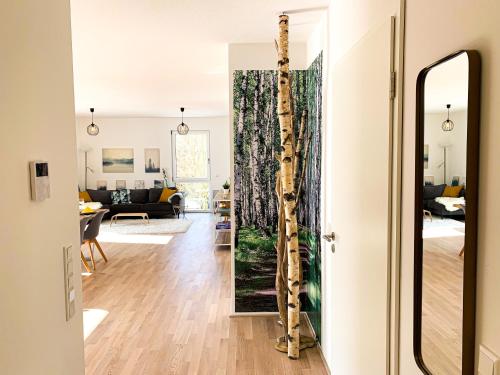 a living room with a tree trunk in a mirror at Home away from Home in a lovely vine region Bingen in Bingen am Rhein
