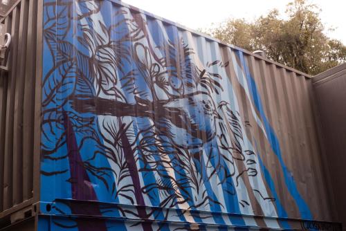 a fence with a blue and white mural on it at KŌN - Pousada Romântica in São Francisco de Paula