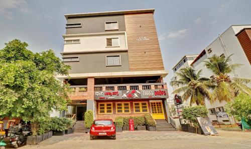 a red car parked in front of a building at Treebo Trend Three Drops in Bangalore