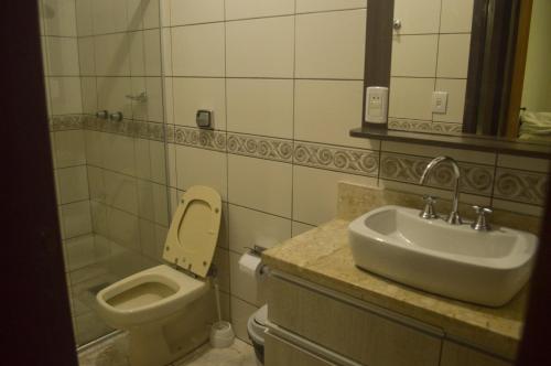 a bathroom with a sink and a toilet at Hotel Costa Dalpiaz in Torres