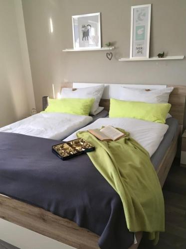a bedroom with two beds with green and white pillows at Ferienwohnung Loretta in Traben-Trarbach