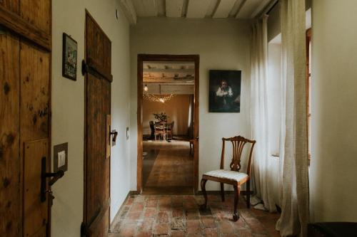 a hallway with a door and a chair in a room at Kalēju ielas rezidence: Talsu vecpilsētas pērle in Talsi