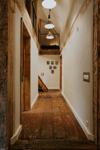 an empty hallway in an old building with wooden floors at Kalēju ielas rezidence: Talsu vecpilsētas pērle in Talsi