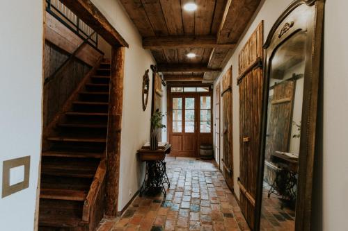 a hallway with wooden ceilings and stairs in a house at Kalēju ielas rezidence: Talsu vecpilsētas pērle in Talsi