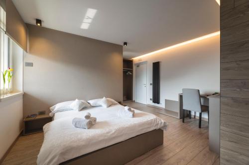 a bedroom with a bed with a teddy bear on it at Hotel Castel Mani in San Lorenzo in Banale