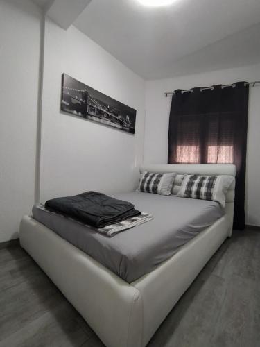 a white bed in a room with a window at Apartment Maska in Budva