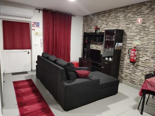 a living room with a couch and a chair at Maison de vacances et week-end, 2 in Esposende