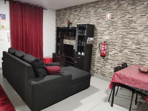 a living room with a couch and a table at Maison de vacances et week-end, 2 in Esposende