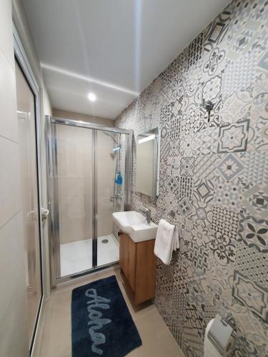 a bathroom with a shower and a sink at B&S Accommodation Penthouse 602 in Hal Ghaxiak