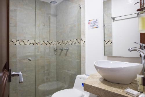 a bathroom with a toilet and a sink and a shower at Casa Centenario in Cartagena de Indias