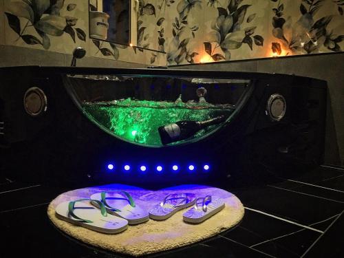 a pair of purple shoes in front of a bath tub at Lovers in Fiuggi in Fiuggi