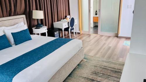 a hotel room with a bed and a desk at Villas at Oceanami Resort in Long Hai