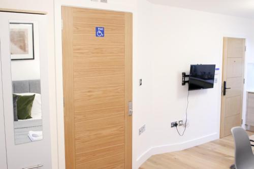a door with a sign on it in a room at Lovely Studio Apartment with access for Wheel-chairs in Sydenham in Forest Hill