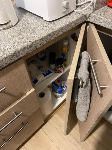 a kitchen counter with a drawer with a towel in it at Apart Hotel R&P Depto B in Puerto Varas