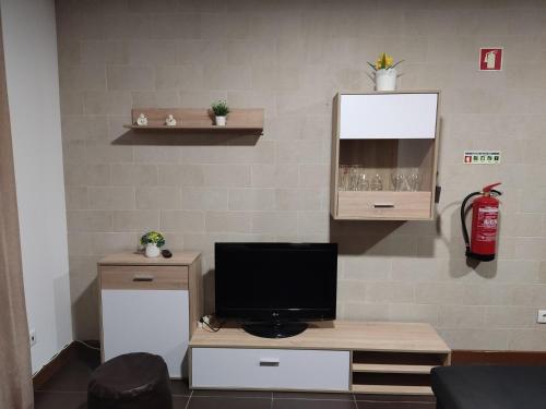 a living room with a television on a table at Holiday home and weekends, 4 in Esposende