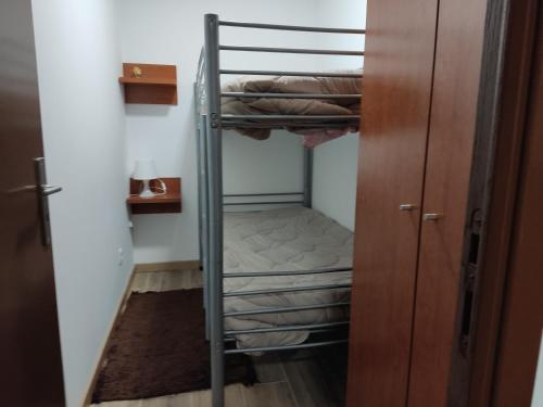 a bunk bed in a room with a closet at Holiday home and weekends, 4 in Esposende