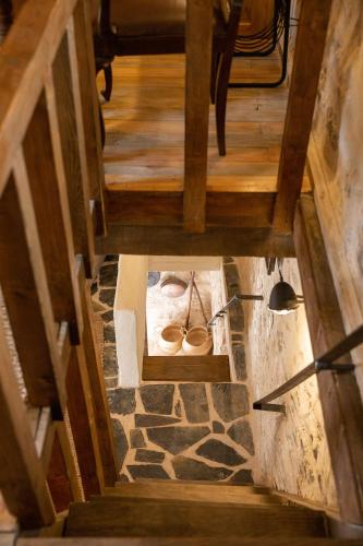 an overhead view of a stone staircase with wooden floors at Dandy Villas Mani - Old Tower House - Fireplace - Pool in Nómia