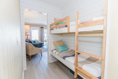 a bedroom with bunk beds and a living room at Stunning Views!!-Oceanfront Villa-Heated Pool-Private Balcony-Tiki Bar-Walk to Coligny Plaza in Hilton Head Island
