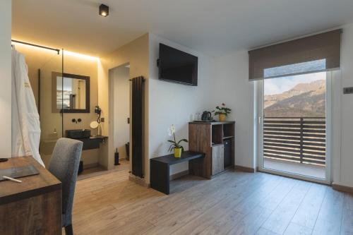 a hotel room with a view of a balcony at Hotel Castel Mani in San Lorenzo in Banale