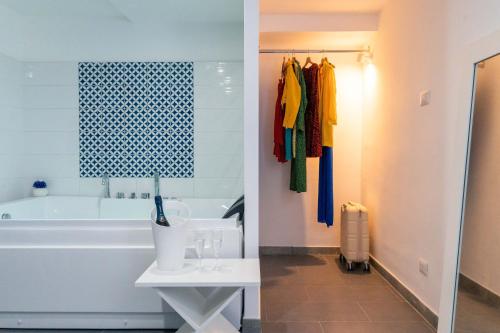 a bathroom with a tub and a sink next to a bath tub at Hotel & Spa Relais Freedom Club in Massa Lubrense