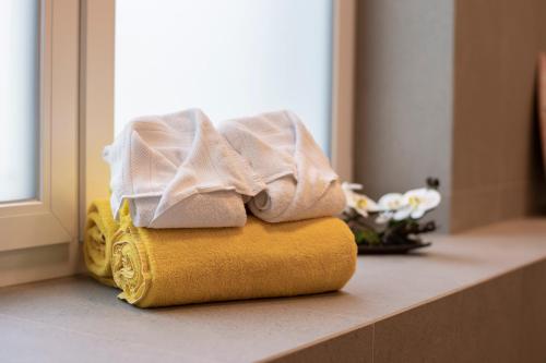 a pile of towels sitting on a counter in a bathroom at Giesserei in Arbon