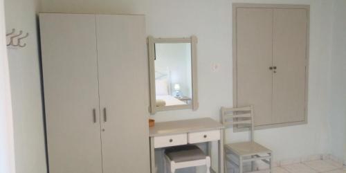 a white bathroom with a mirror and a sink at San Giorgio in Gaios