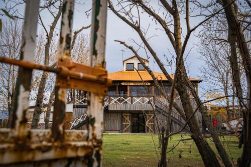 a large house in the middle of a yard at Hotel Hacienda Dorotea in Puerto Natales