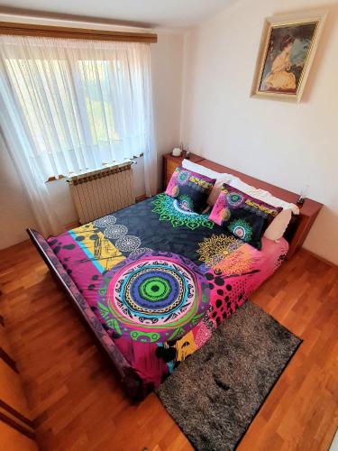 a bedroom with a large bed with colorful pillows at Lux D'Or Apartment in Pula