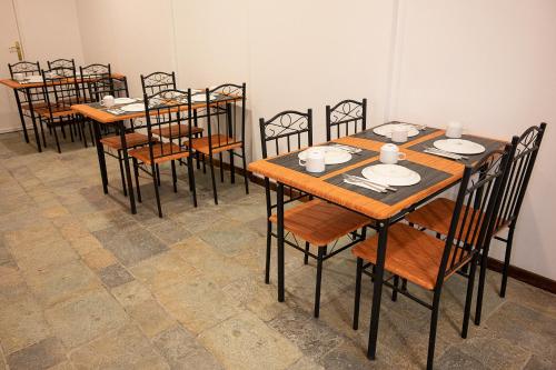 a group of tables and chairs in a room at Dionysos Hotel in Poros