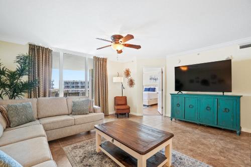a living room with a couch and a flat screen tv at Destin West - Heron in Fort Walton Beach