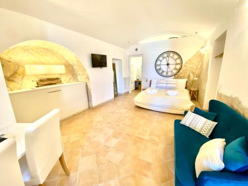a living room with a couch, chair and a television at Il Sorriso Dei Sassi Rooms in Matera