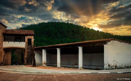a building with a mountain in the background at Casa sala pinta in Castellfort