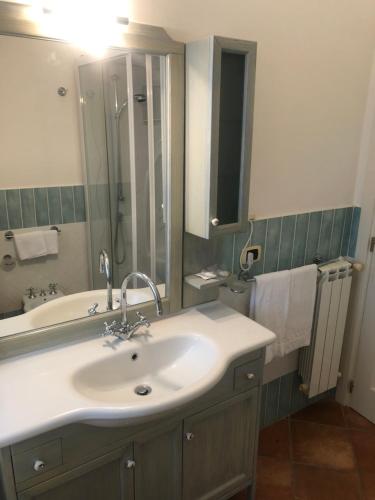 a bathroom with a sink and a shower and a mirror at Torre Archirafi Resort in Riposto