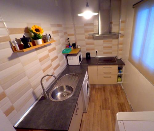a small kitchen with a sink and a washing machine at Apartamento en el centro para 4 personas in Seville