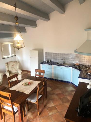 a kitchen with a table and chairs in a room at Torre Archirafi Resort in Riposto