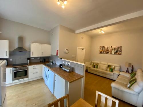 an open kitchen and living room with a couch at Grassmarket apartment in Edinburgh