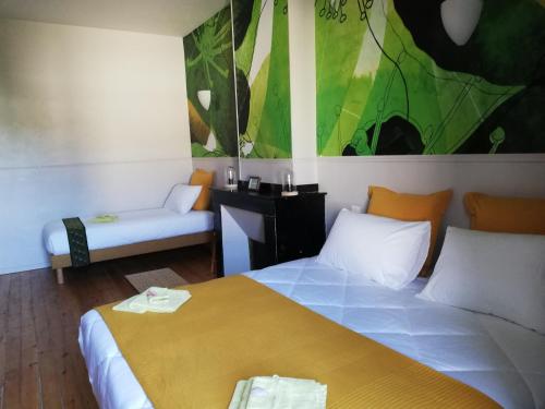 a hotel room with a bed and a couch at Le Clos'art in Vinassan